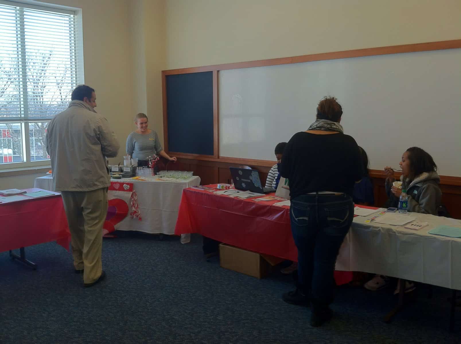 Josh Falcone | General Assignment ReporterStudents and faculty gather around the Heart Healthy fair tables.