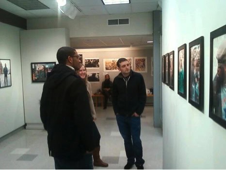 Attendees of Smiley's showcase admiring his work