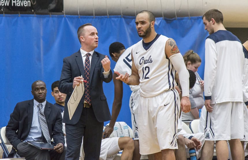 Coach Michael Donnelly talks to Tylon Smith before heading back on the court.