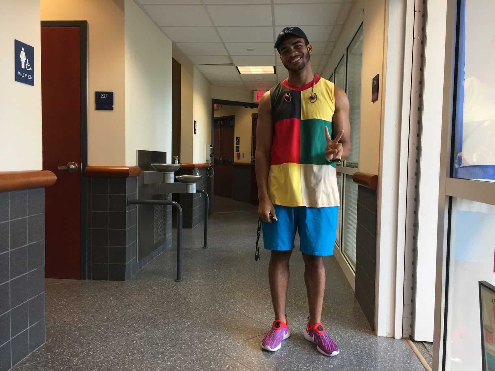 Sammy Maximin, senior business finance major, outfitted in his favorite style: bright clothing which matches his mood.